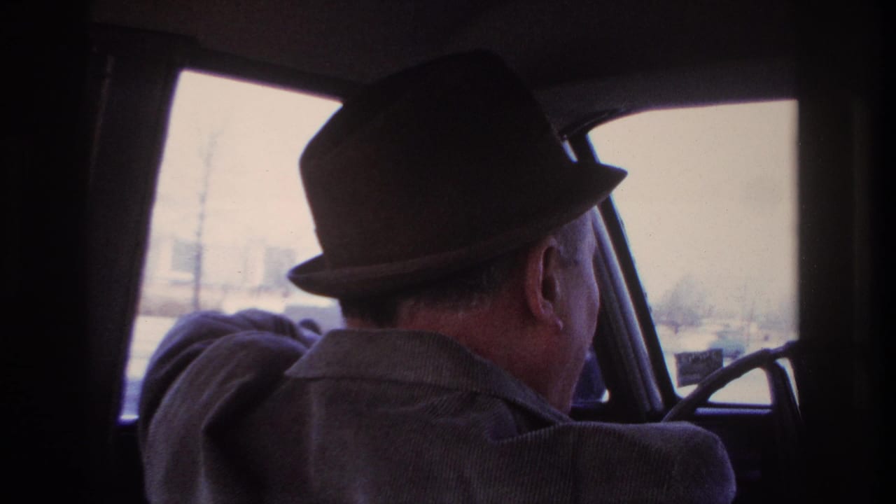 1966 Hoboken driving view from behind the driver, with the steering wheel and washed-out city scene ahead.