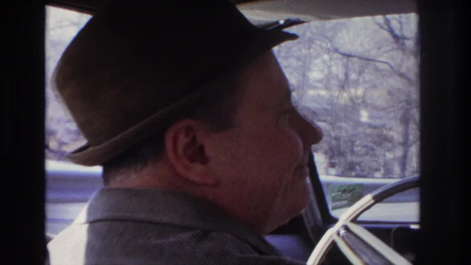 Final frame shows the 1966 Hoboken-area driver from the passenger side, with his hat, profile, steering wheel, and passing trees visible.