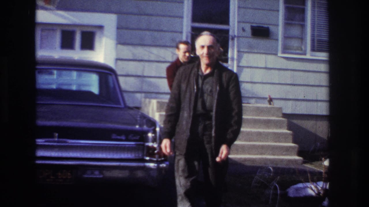 In Hoboken, New Jersey, 1966 home-movie footage, an older man walks near a dark sedan while two men stand by house steps.