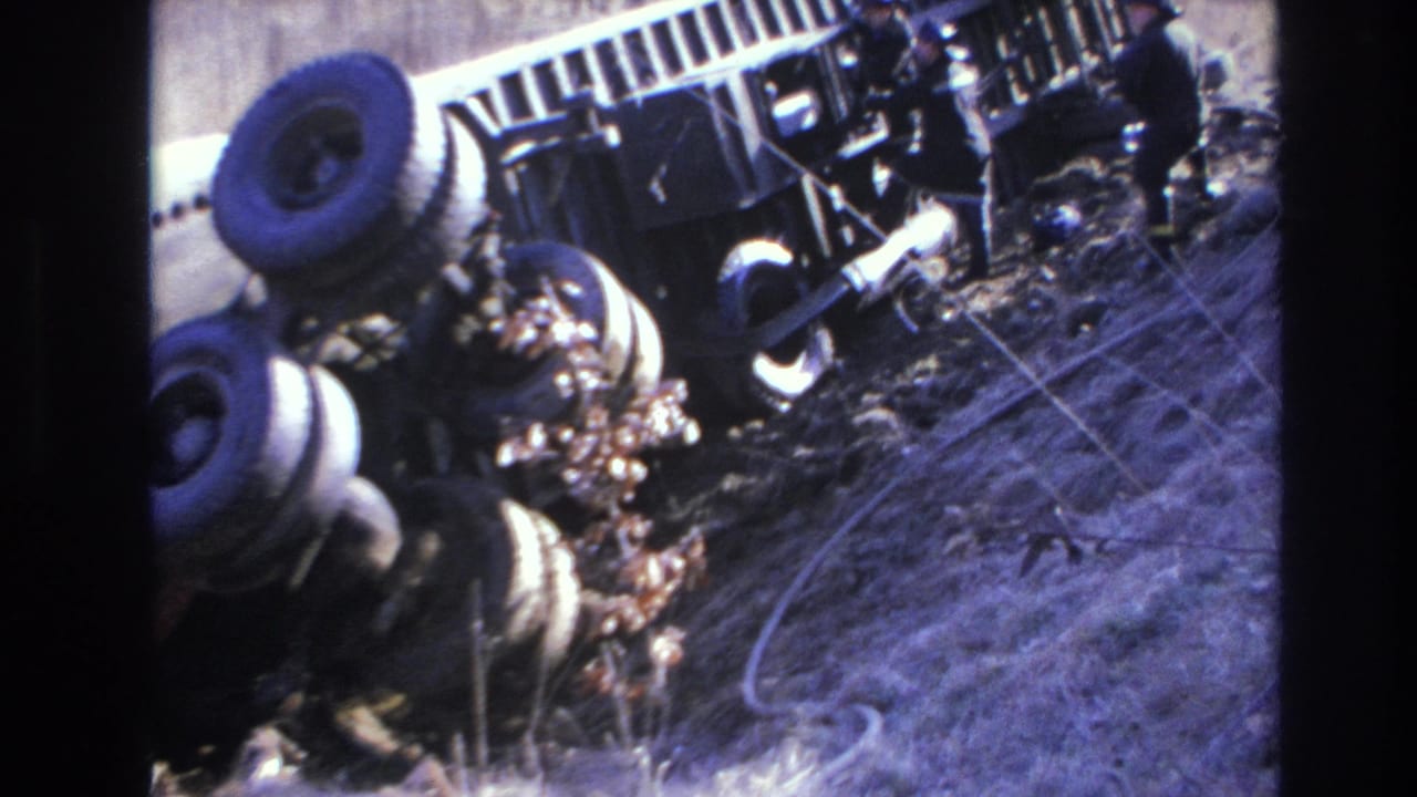 1966 Hoboken 8mm frame showing an overturned truck partly obscured by dry grass and debris.