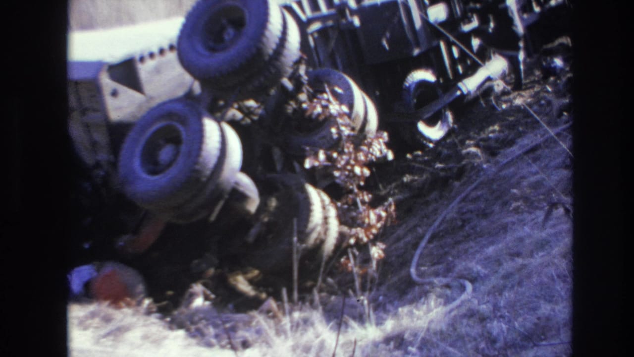 Closer view of the overturned truck and ditch grass.