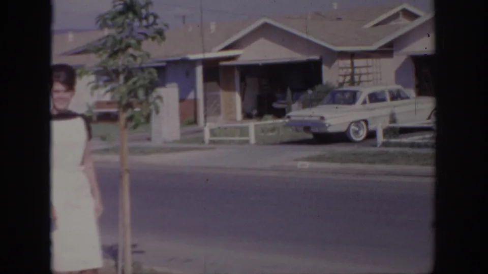 The final frame places the woman near the edge as a classic car and ranch house fill the Sacramento neighborhood background.