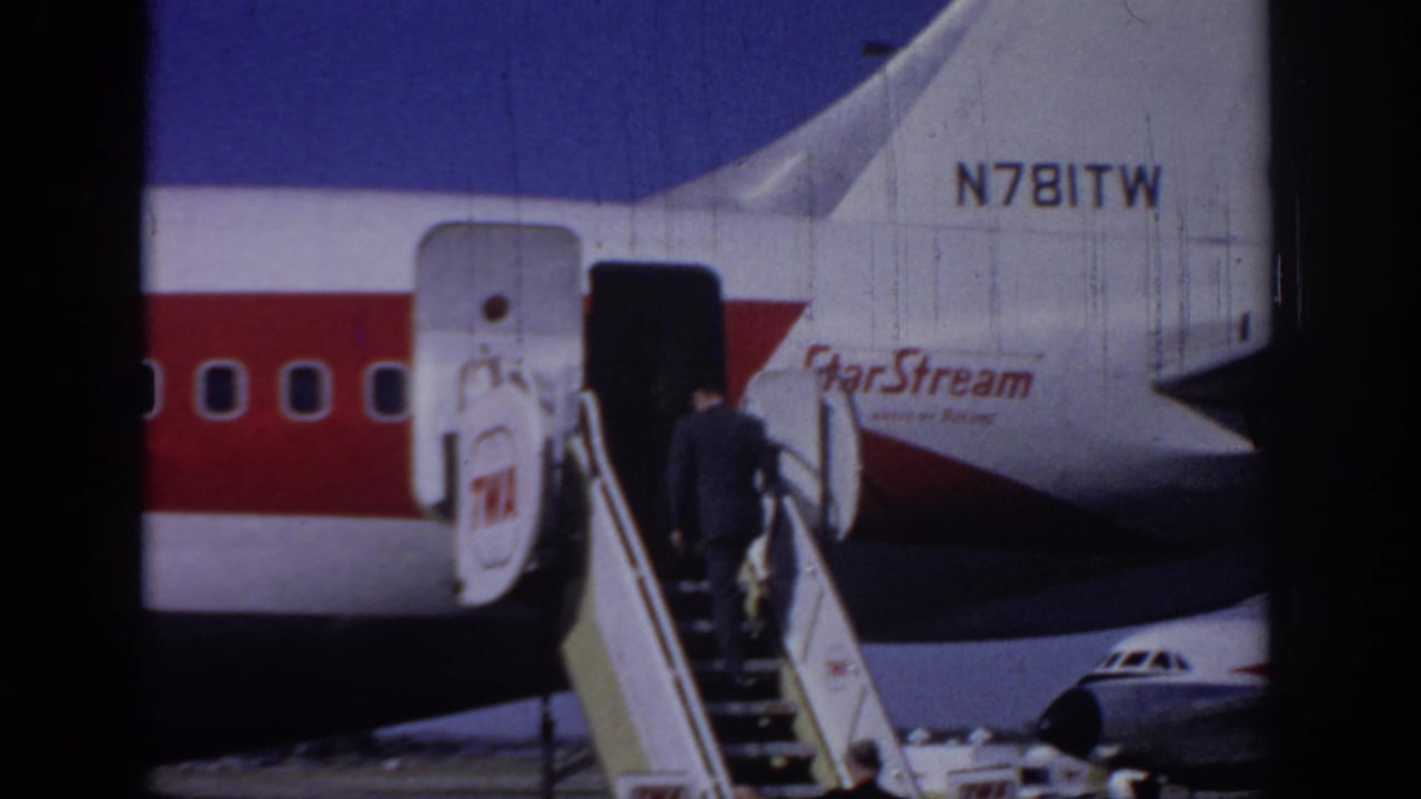1966 Sacramento airport footage shows a suited adult boarding a StarStream-marked jet by mobile stairs, with registration text visible on the tail.