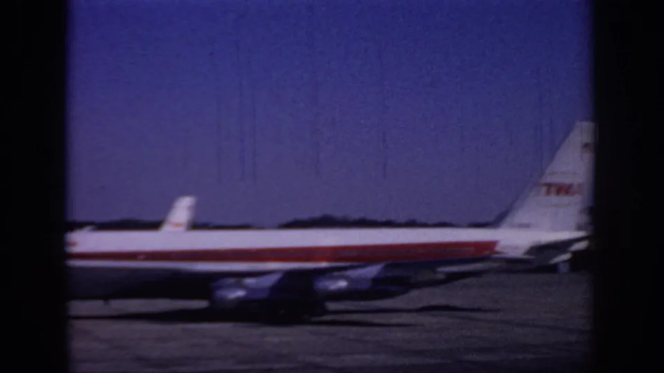 1966 Sacramento airport frame with the TWA jet's rear fuselage and tail visible as it taxis past the camera.