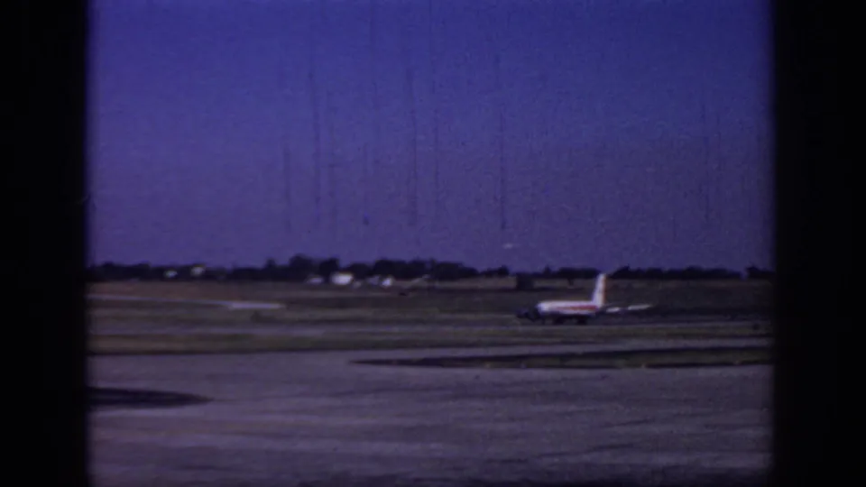 Wider 1966 Sacramento airport view showing the TWA jet at a distance on the runway or taxiway.