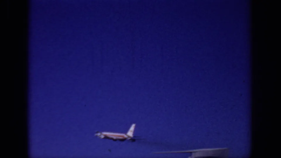 The commercial jet appears farther from the camera as it climbs into the blue Sacramento sky in 1966 footage.
