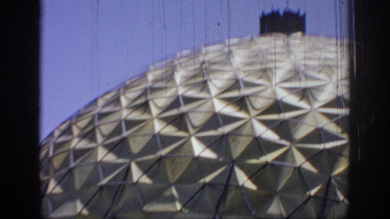 Final 1967 Oklahoma frame with the gold dome partly cropped by the moving vehicle view and dark film-frame edges.
