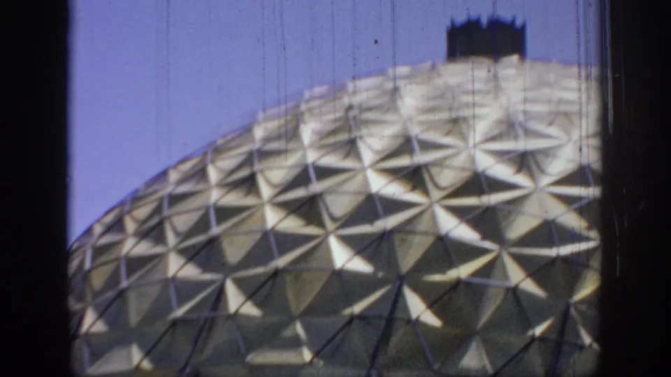 Final 1967 Oklahoma frame with the gold dome partly cropped by the moving vehicle view and dark film-frame edges.