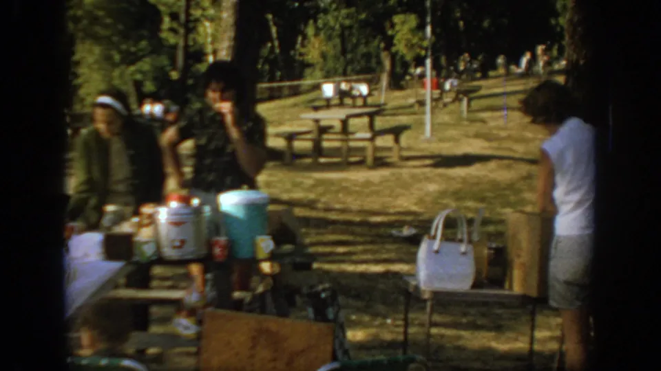 The final frame shows women and picnic supplies at shaded park tables in Oklahoma, with coolers, bags, benches, and trees visible.