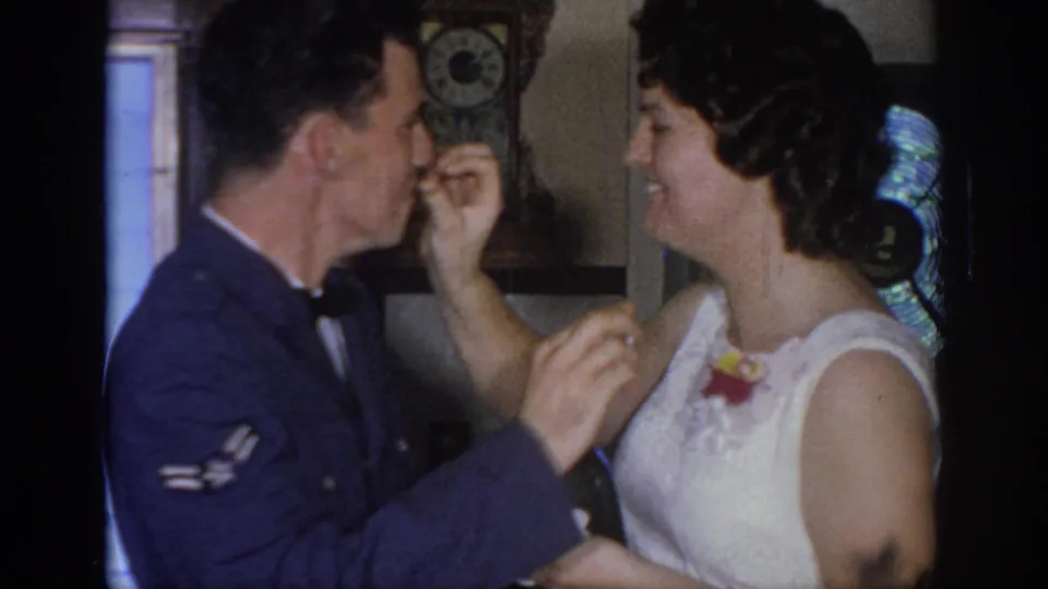 The woman smiles as she and the uniformed man continue feeding each other cake inside the private celebration space.