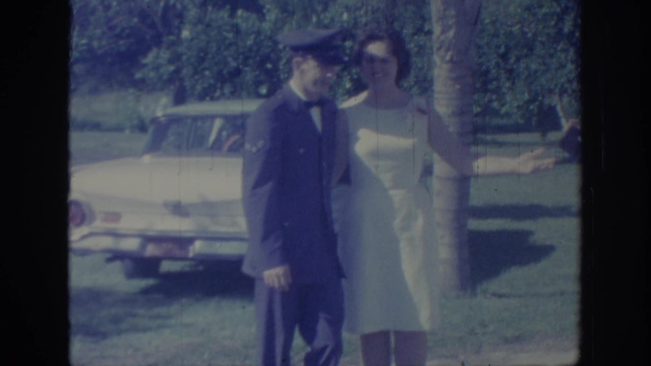 The 1967 Oklahoma frame shows the uniformed man and woman in white posing near a tree, with a pale car and lawn behind them.