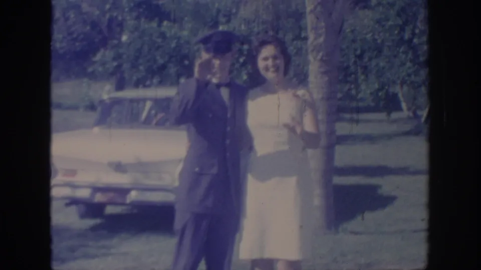 In the final 1967 Oklahoma frame, the uniformed man waves at the camera while the woman smiles beside him near the parked car.