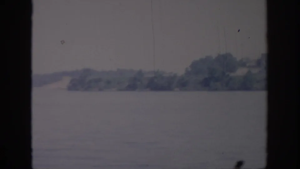 1967 Oklahoma 8mm view of a wooded shore across a broad body of water, softly focused and faded.