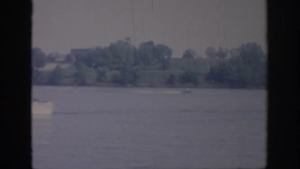 The white boat is partly cropped at the left edge as it moves across the lake in the 1967 Oklahoma home movie.