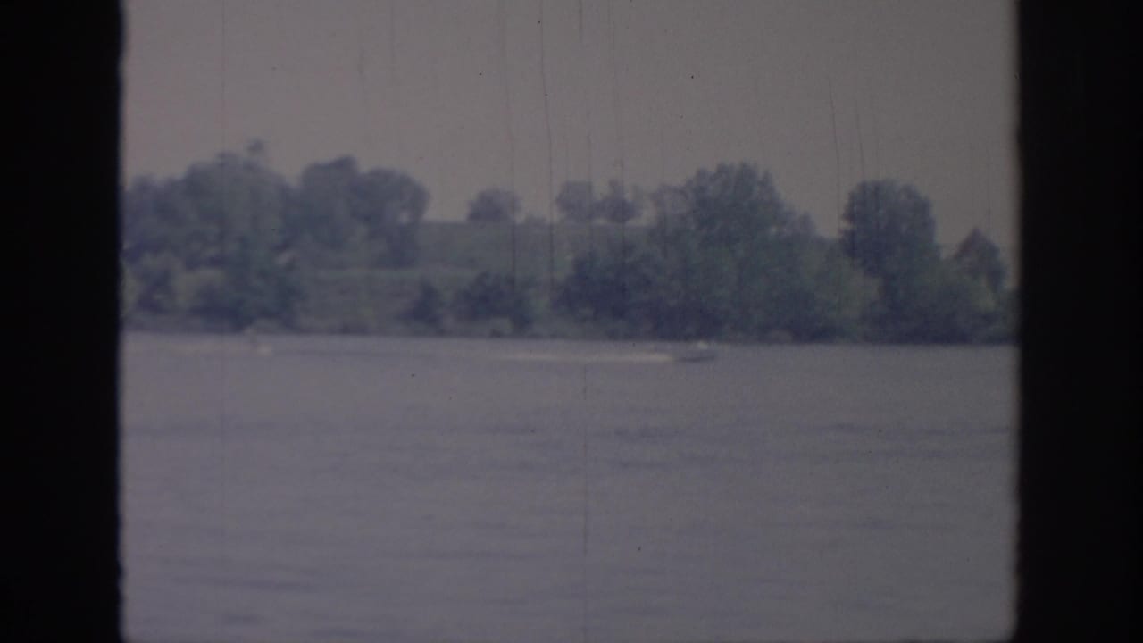 The final 1967 Oklahoma frame shows calm lake water, a wooded shore, and little or no boat remaining visible.