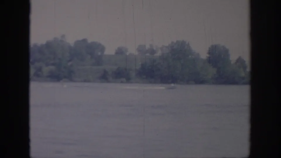 The final 1967 Oklahoma frame shows calm lake water, a wooded shore, and little or no boat remaining visible.