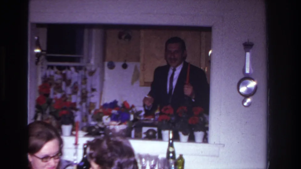 A 1967 Rockaway Beach party scene shows a suited man with a red candle in the kitchen and seated guests below the doorway.