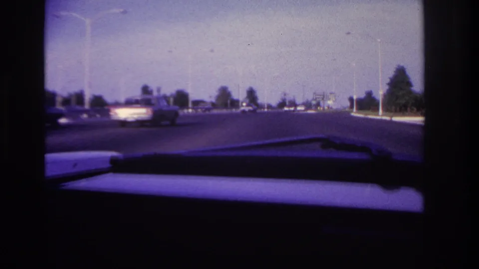 1967 Rockaway Beach road footage from inside a car, showing a passing vehicle, open lanes, roadside trees, and a windshield wiper.