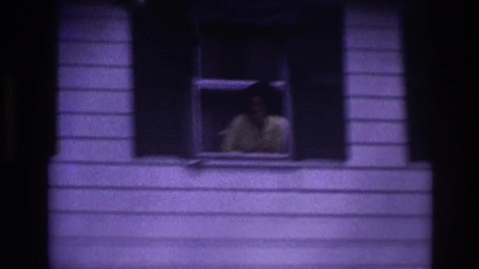 Rockaway Beach 1967 frame with a woman partly visible in an open window, seen through soft purple 8mm color.