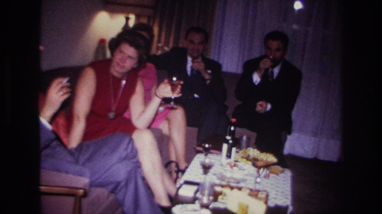 1967 Rockaway Beach gathering with a woman holding a wine glass and suited men drinking in the background.
