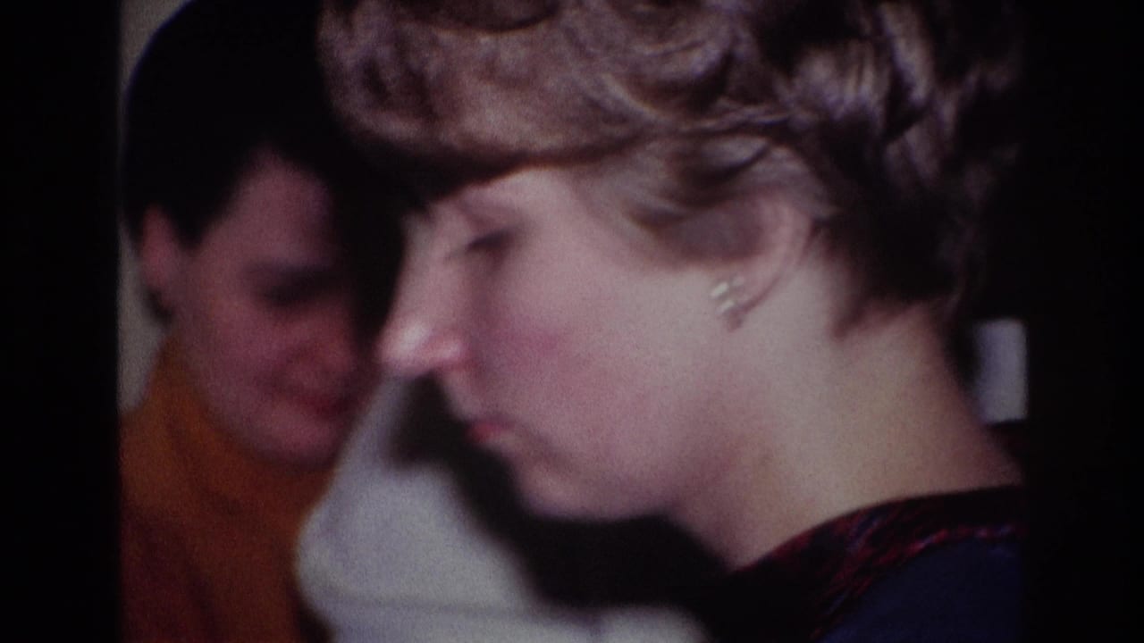 1967 Rockaway Beach home-movie frame showing a woman at a piano in a living room as two seated women watch behind her.