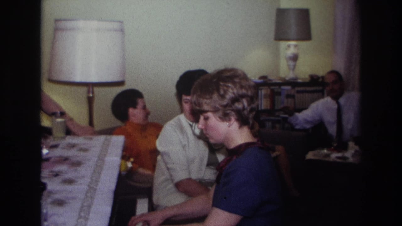 1967 Rockaway Beach frame with the pianist in profile and several adults seated behind her in a domestic interior.