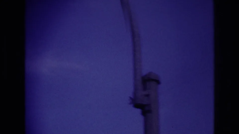 A silhouetted airplane appears in a purple-blue sky in 1967 Rockaway Beach home-movie footage, with dark frame edges visible.