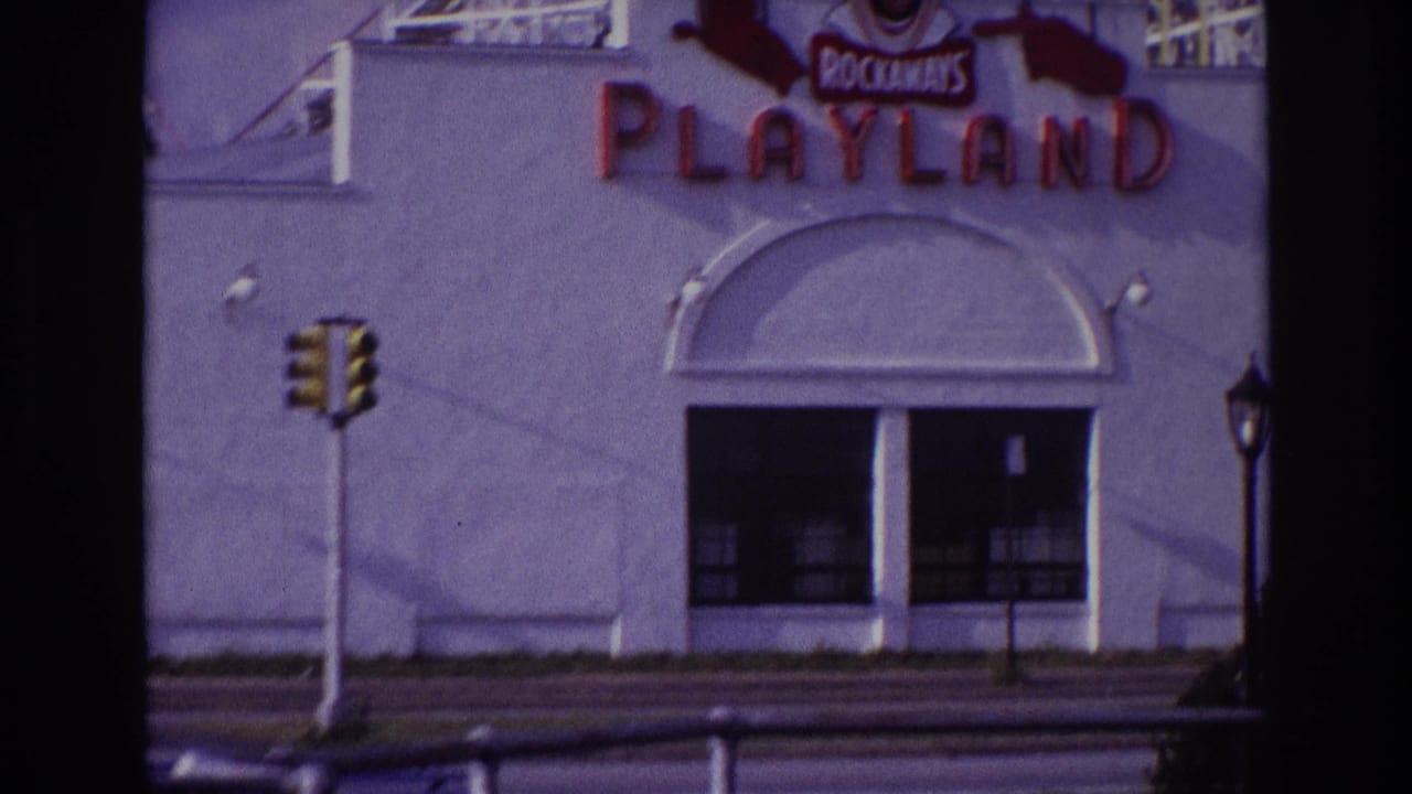 Rockaways Playland entrance facade with traffic lights and roller coaster structure above.
