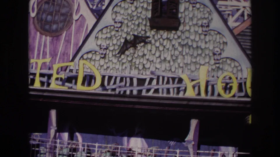 Rockaway Beach 1967 frame with the TEDDY HOUSE sign, gothic facade details, dark awning, and a glimpse of railing below.