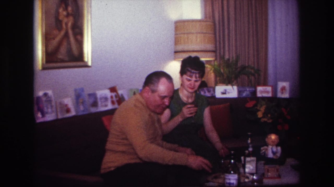 In 1967 Rockaway Beach home-movie footage, a seated couple shares drinks in a living room lined with holiday cards.