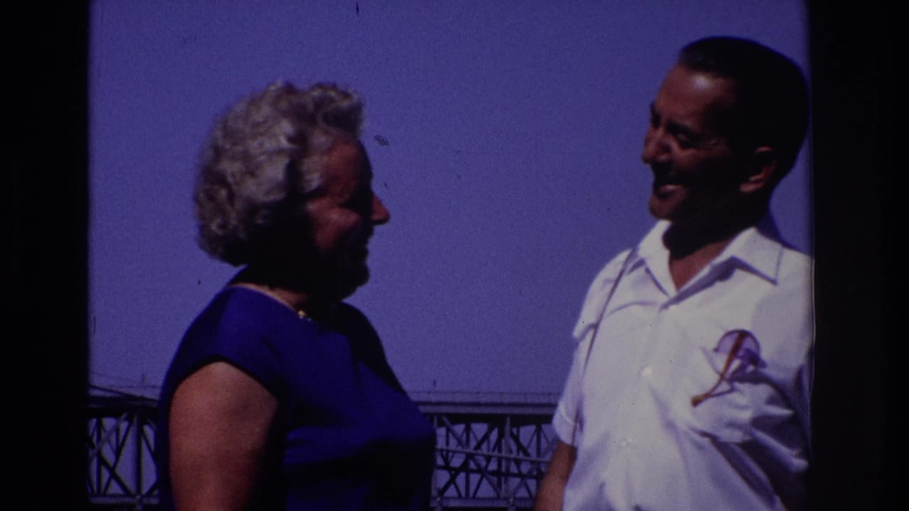 1968 Ocean City, New Jersey home-movie frame of a smiling adult couple standing close together with a bridge behind them.