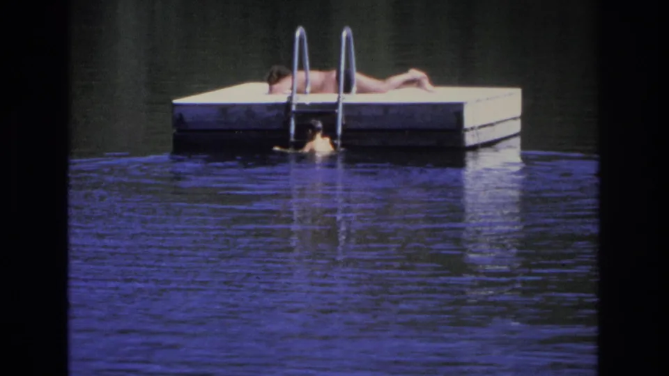 1968 Ocean City frame with a swimmer near the dock ladder and a sunbather stretched out on the floating dock.