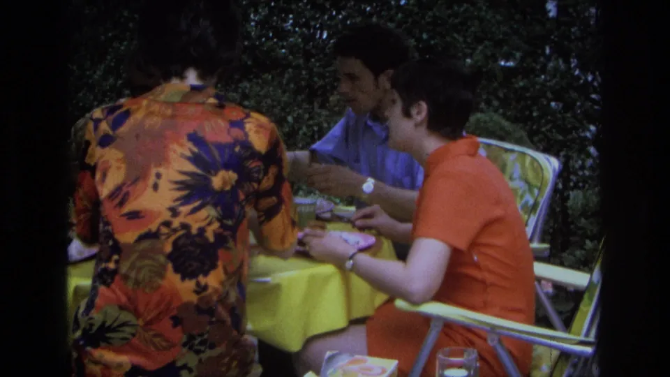 At the end of the clip, three adults remain seated at the outdoor table in Ocean City, New Jersey, with plates and a glass visible.