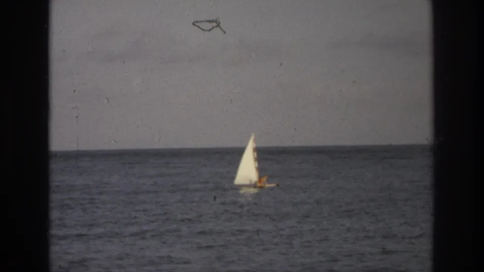 The sailboat continues across the open ocean in metadata-supported 1968 Ocean City, New Jersey footage.