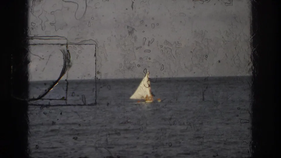 A small white sail remains visible offshore, with heavy 8mm scratches and gate edges over the Ocean City seaside view.