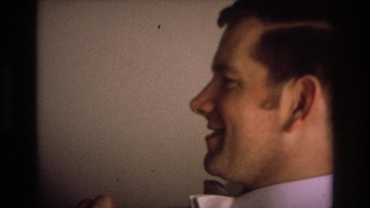A close 8mm frame shows a man laughing in profile in a private indoor setting associated with Ocean City, New Jersey, 1968.