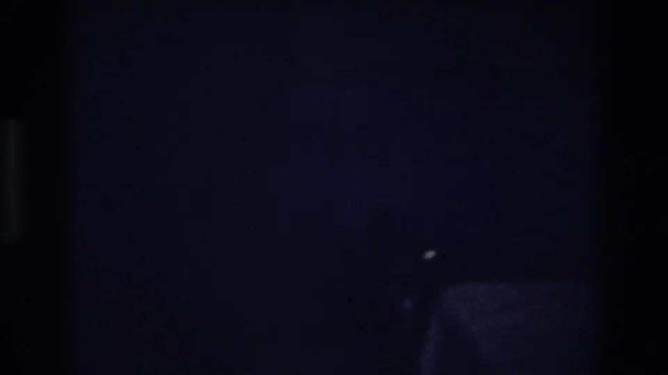 1968 Ocean City home-movie frame showing a man in glasses partly visible in a dark interior.