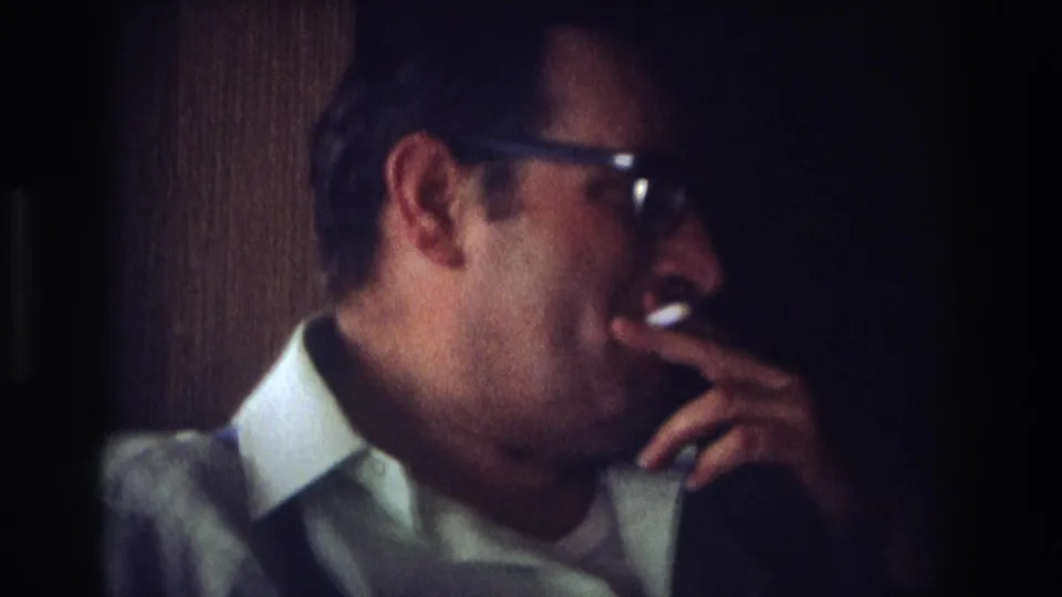 1968 Ocean City home-movie profile of a middle-aged man smoking indoors against a dark background.