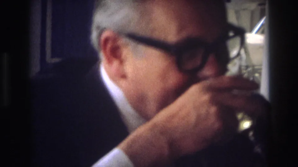 A man in glasses drinks from a glass in a close, softly focused 1968 Ocean City, New Jersey home-movie frame.