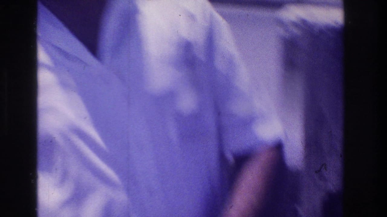 Soft 1968 Ocean City home-movie frame showing a man in a white short-sleeved shirt near the boardwalk camera.