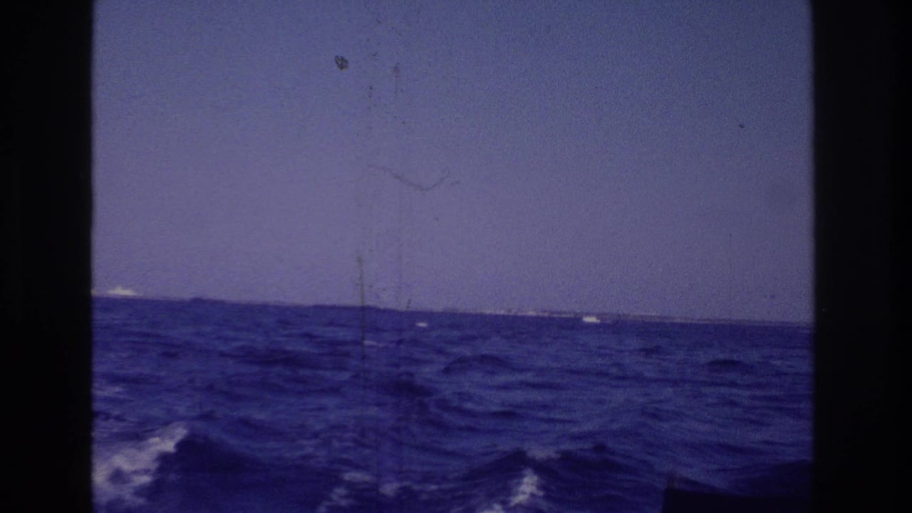 1968 Ocean City, New Jersey home-movie view from a boat, showing blue choppy water, low horizon, and distant land.