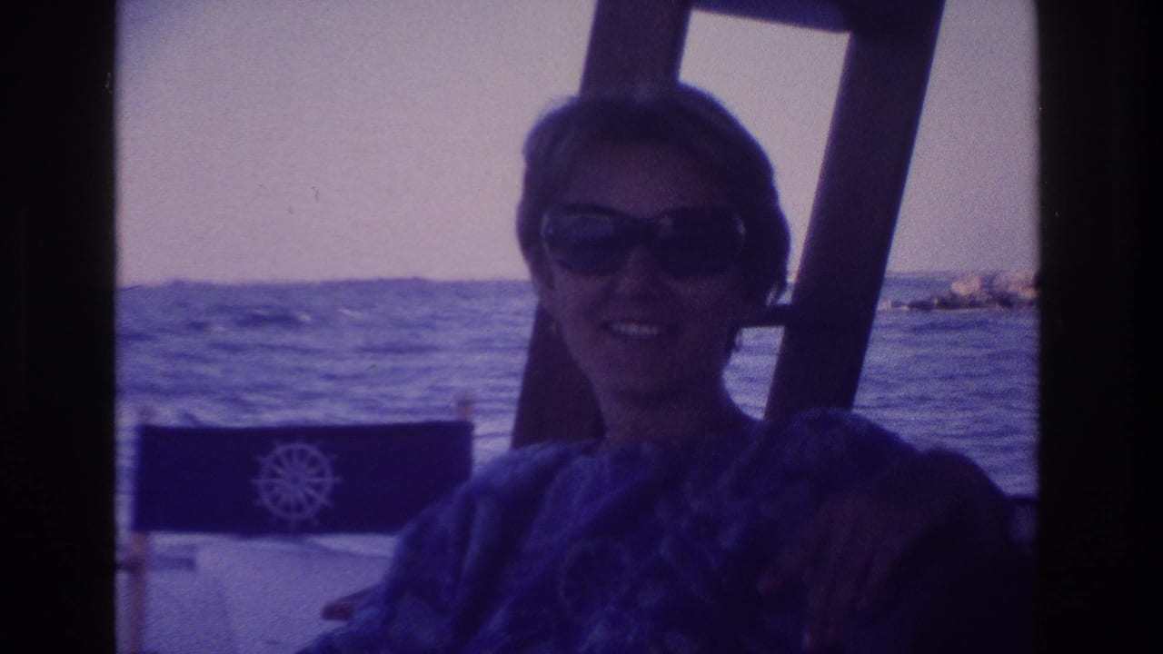 1968 Ocean City, New Jersey home-movie frame of a woman in dark sunglasses seated on a boat near open water.