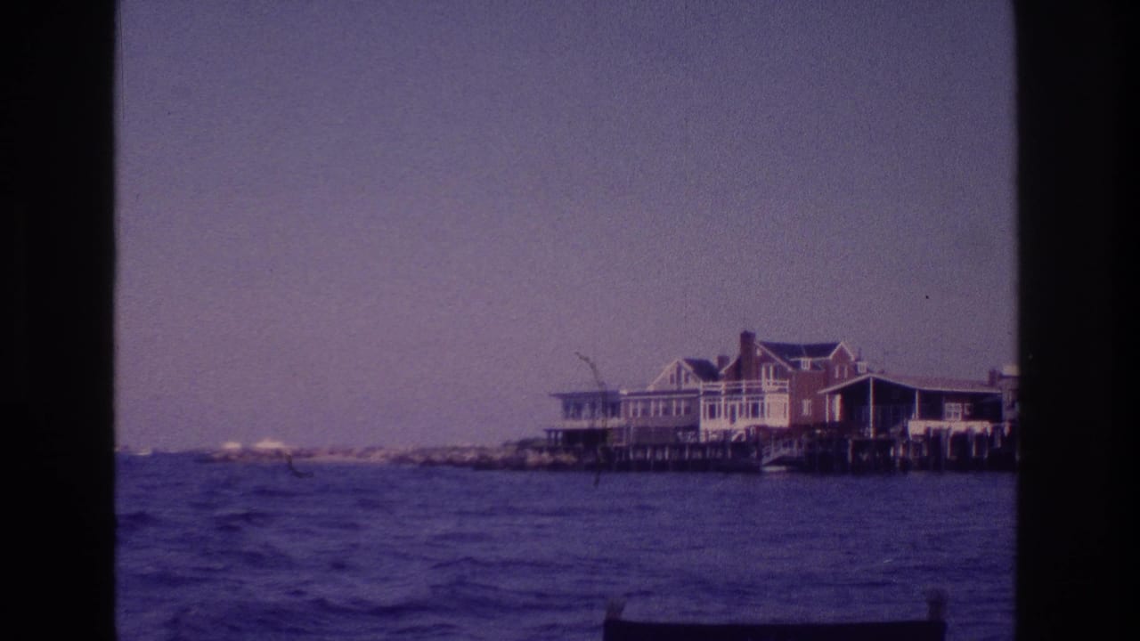 1968 Ocean City, New Jersey 8mm frame showing bay water and coastal houses on wooden pilings from a moving boat.