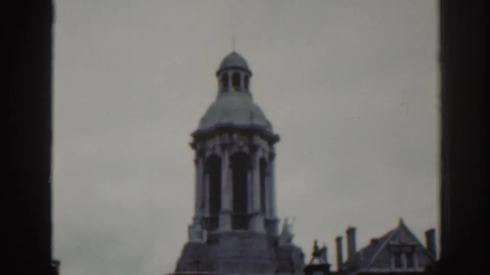 1961 Dublin home-movie view of a domed stone tower top with arched openings and nearby gabled architecture.