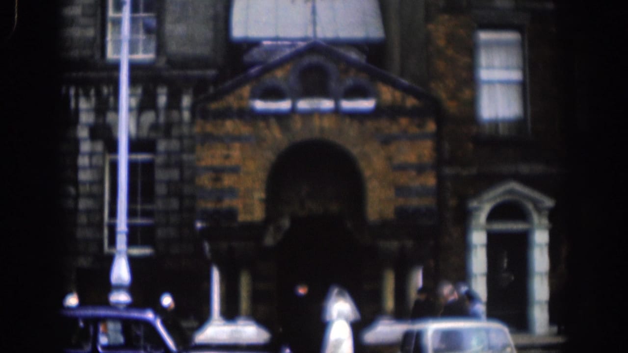 1961 Dublin church exterior showing the entrance, brick facade, wedding guests, a parked car, and a streetlamp.