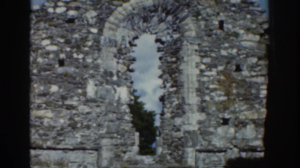 Stone ruin detail in Dublin, 1961, with a tall arched opening framed by rough masonry.