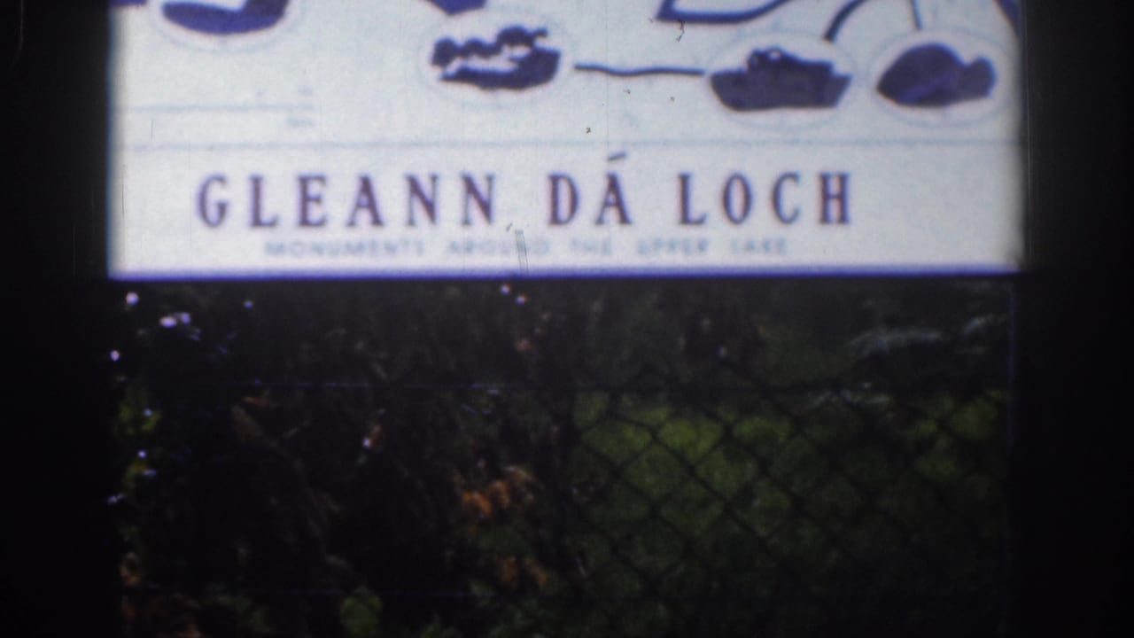 Close 8mm frame of a Gléann Dá Loch sign, with smaller Upper Lake wording partly visible below.