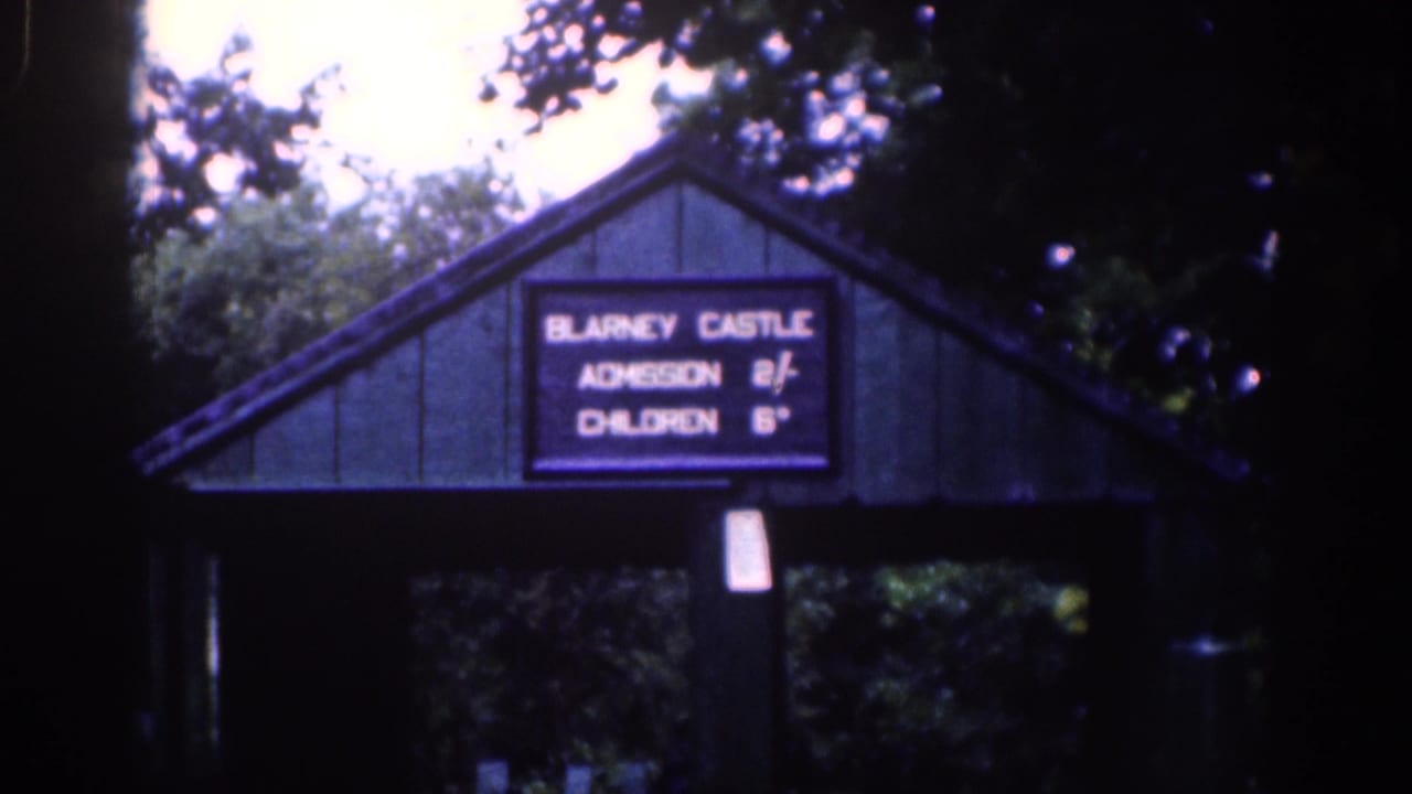 Timber entrance structure with a Blarney Castle admission sign under trees.