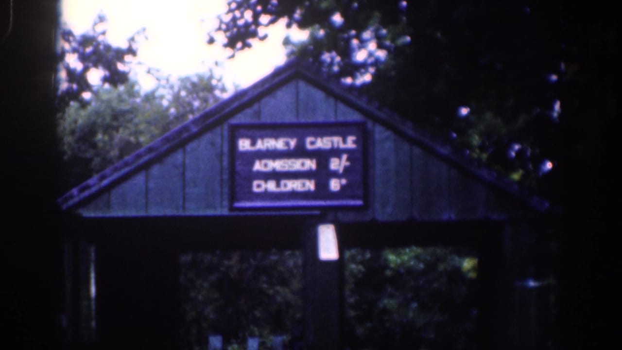 Blarney Castle entrance sign repeated in a dark, tree-framed shot.