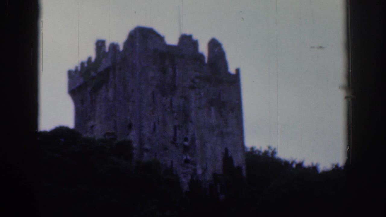 1961 Dublin 8mm frame showing a large crenellated stone ruin partly obscured by trees against a pale sky.
